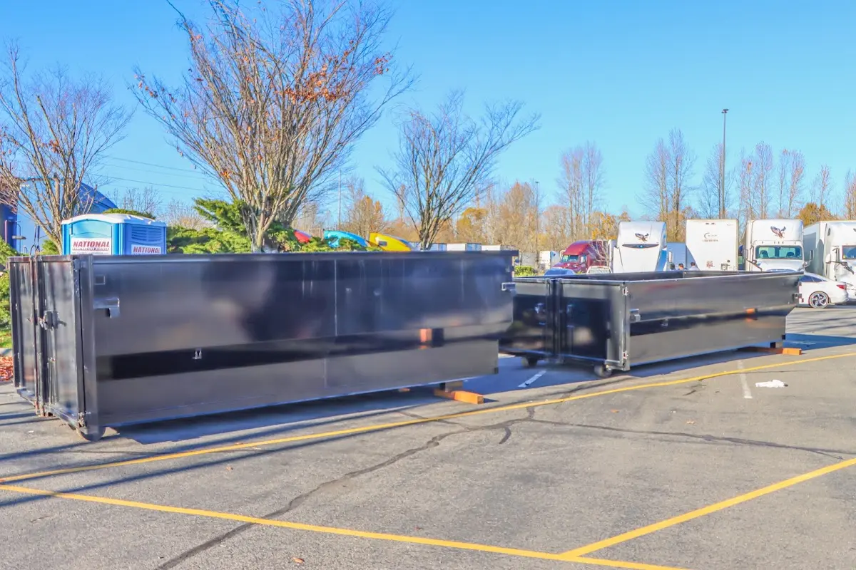 Professional dumpster rental service with roll-off container on residential driveway in Coos Bay
